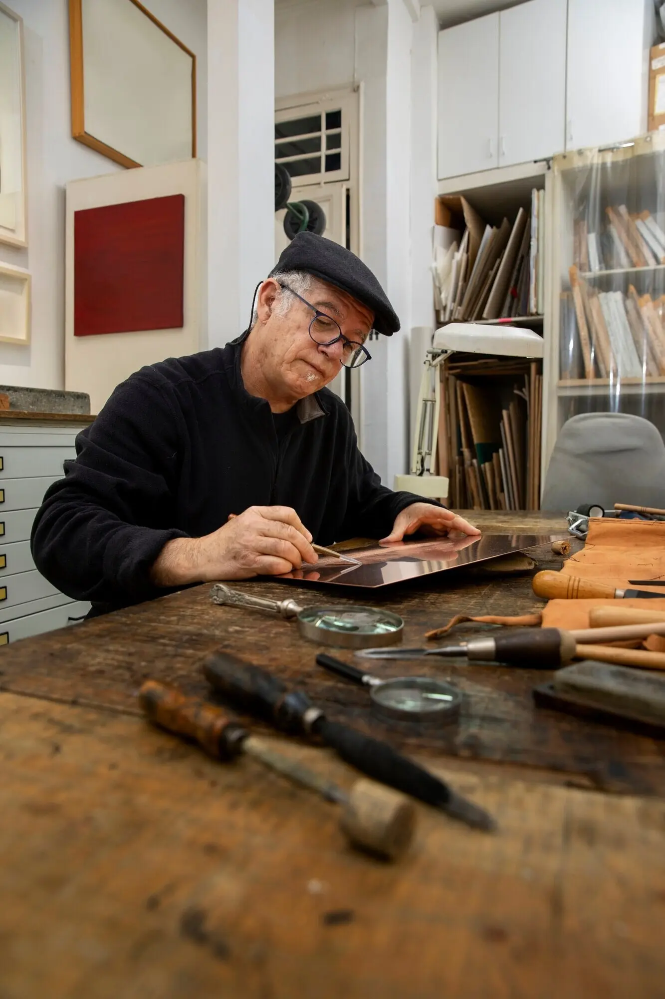 Close-up of a person working on an engraving.