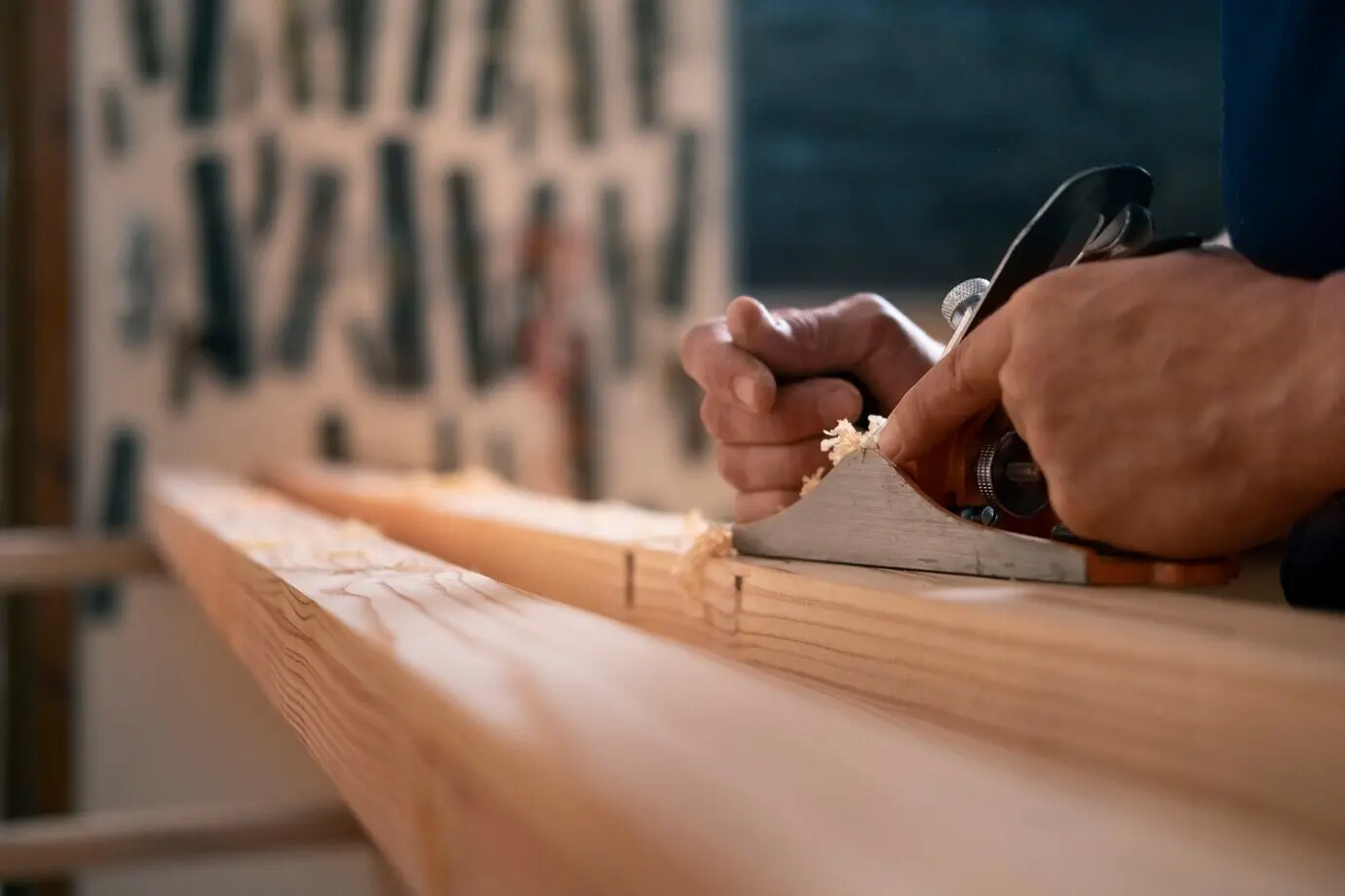 A male woodworker in his workshop using tools and equipment.