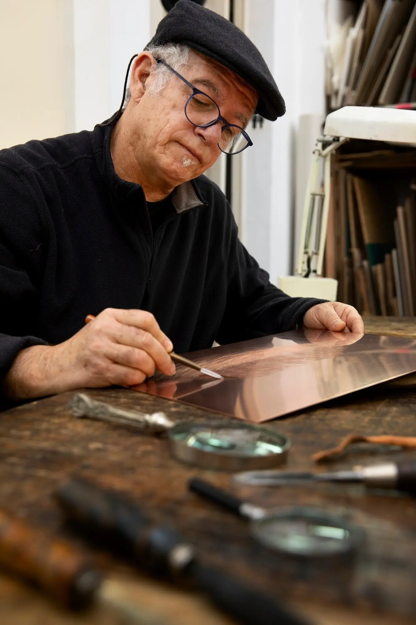 A close-up shot of a person working on engraving.